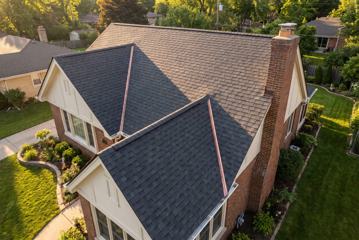 A completed asphalt shingle roof with straight courses and a clean ridge cap